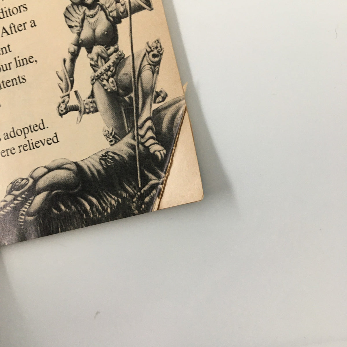 Back cover of VTG Heavy Metal Magazine April 1977, displaying artwork and text featuring a character with a spear, adding to the magazine's fantasy theme.