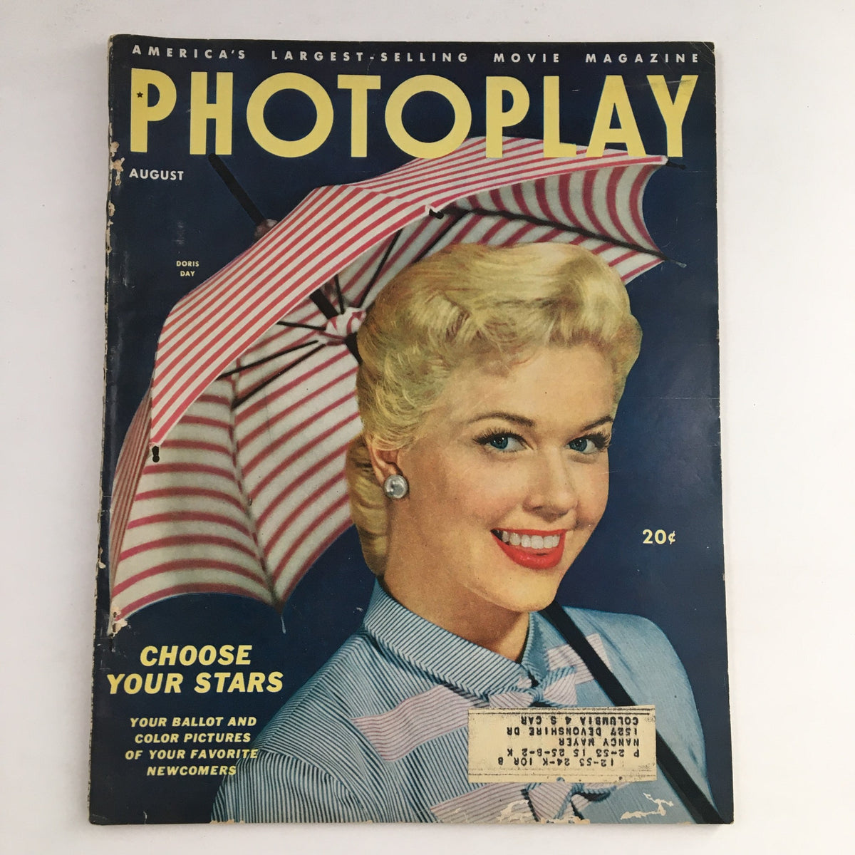 Cover of Photoplay Magazine August 1953 featuring Doris Day with a striped umbrella, showcasing classic Hollywood charm.