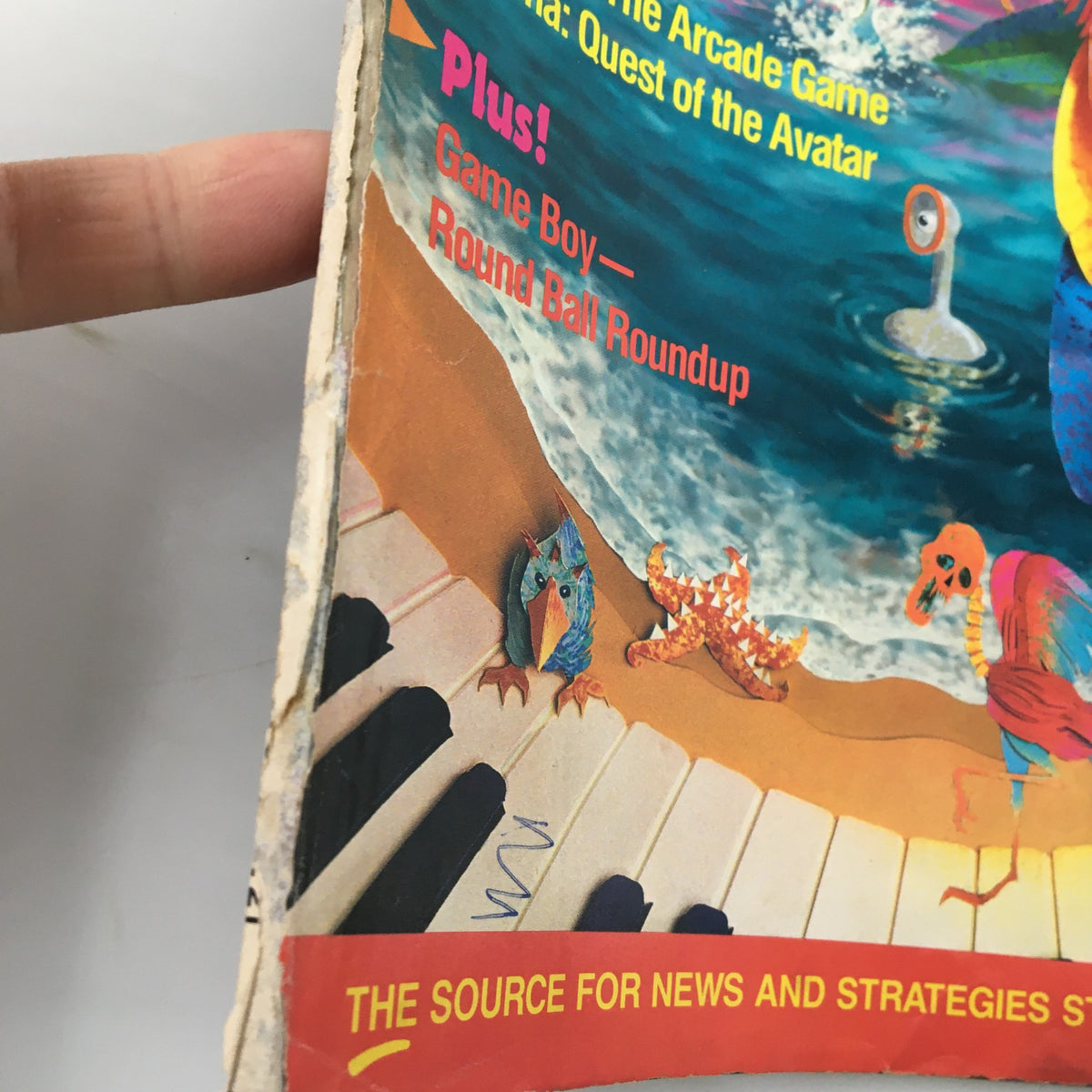 Close-up view of the edge of Nintendo Power Magazine February 1991 #21, highlighting wear and tear with coastal-themed artwork from Star Tropics.