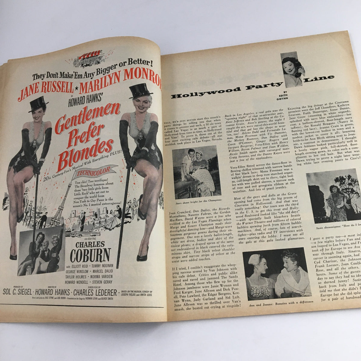 Interior spread from Photoplay Magazine August 1953 showing advertisements for the film 'Gentlemen Prefer Blondes' featuring Jane Russell and Marilyn Monroe alongside an article titled 'Hollywood Party Line'.