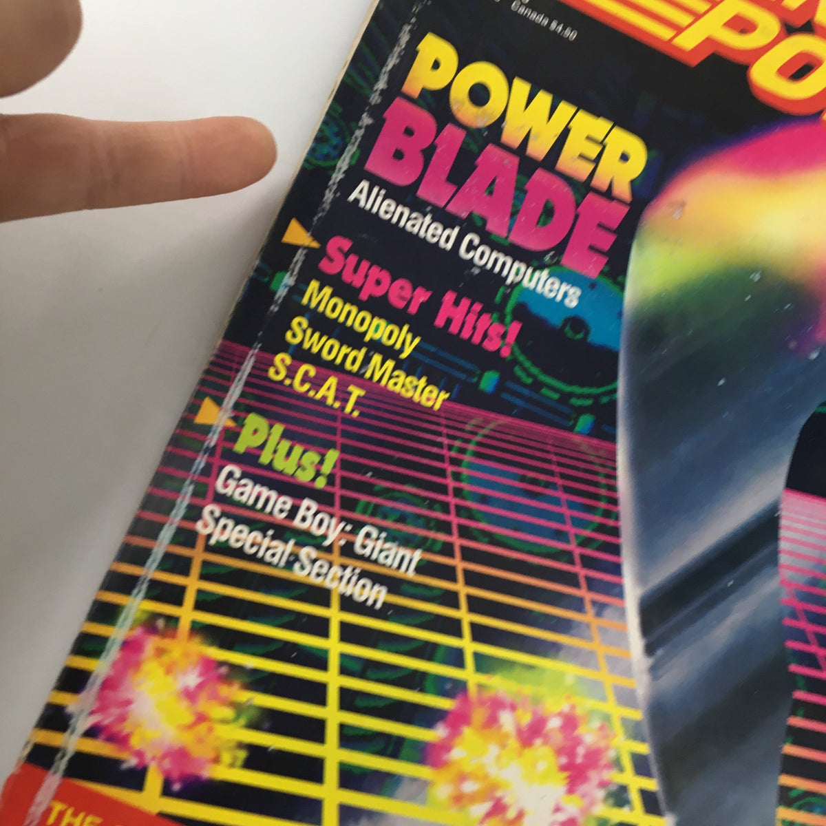 Close-up of the cover of Nintendo Power Magazine April 1991 Issue #23, showcasing Power Blade and Alienated Computers. The design features bold text and neon colors, emphasizing the magazine's focus on video games.