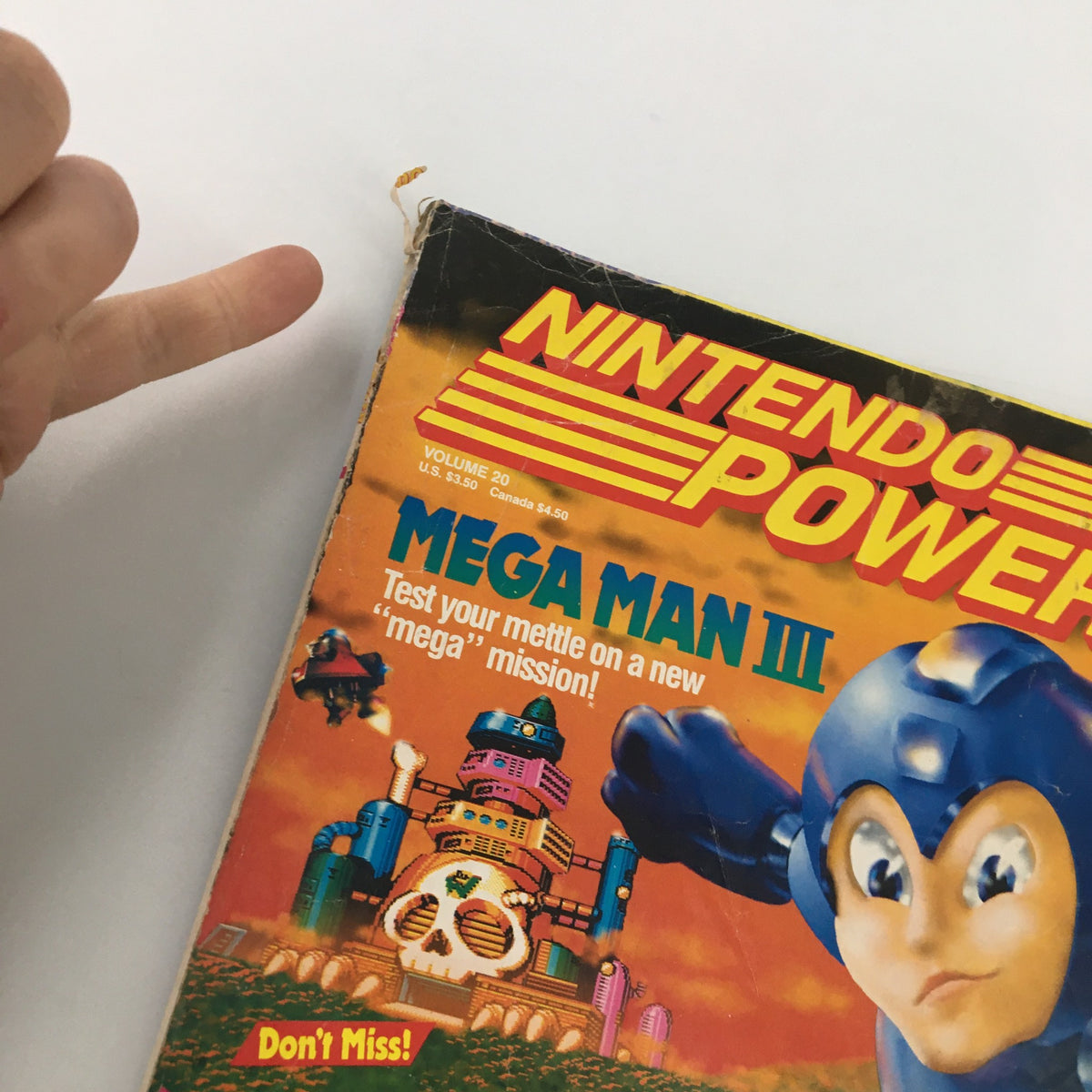 Side view of Nintendo Power Magazine January 1991, Issue #20's cover, highlighting Mega Man III with visible wear on the magazine's edge.