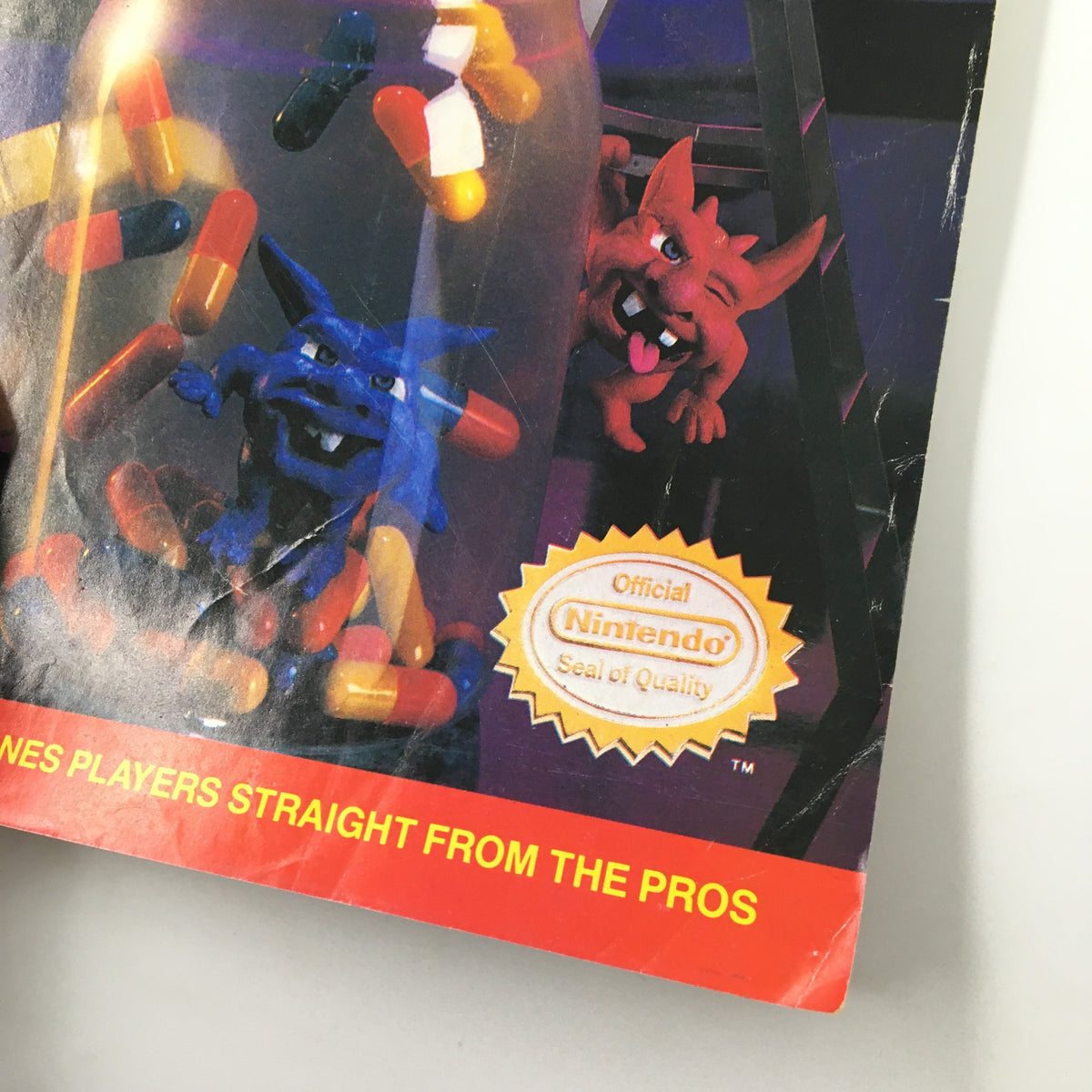 Image highlighting the 'Official Nintendo Seal of Quality' on Nintendo Power Magazine November 1990 #18, showcasing game elements and colorful capsule graphics.