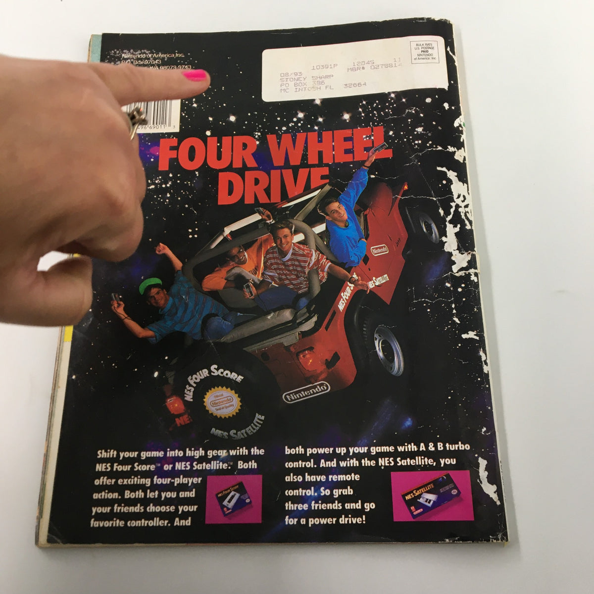 Back cover of Nintendo Power Magazine November 1990 #18 showcasing a vibrant advertisement for NES games and four-player gaming options.