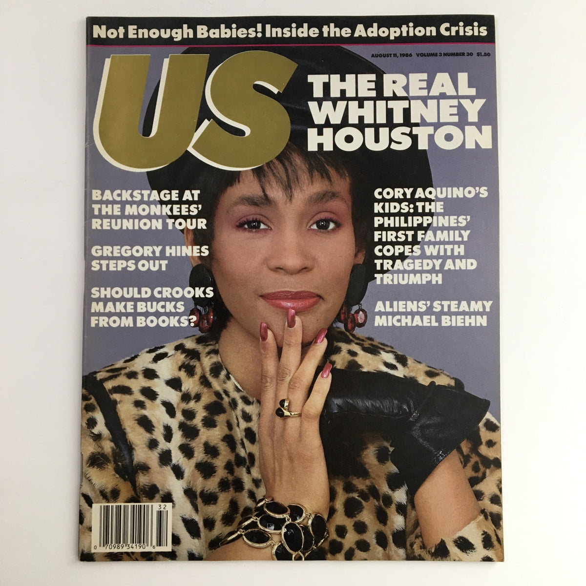 US Magazine cover from August 11, 1986, featuring Whitney Houston prominently displayed, with the title 'The Real Whitney Houston'. The magazine highlights stories about Gregory Hines, backstage at the Monkees' reunion tour, and includes features on various cultural topics from that era.