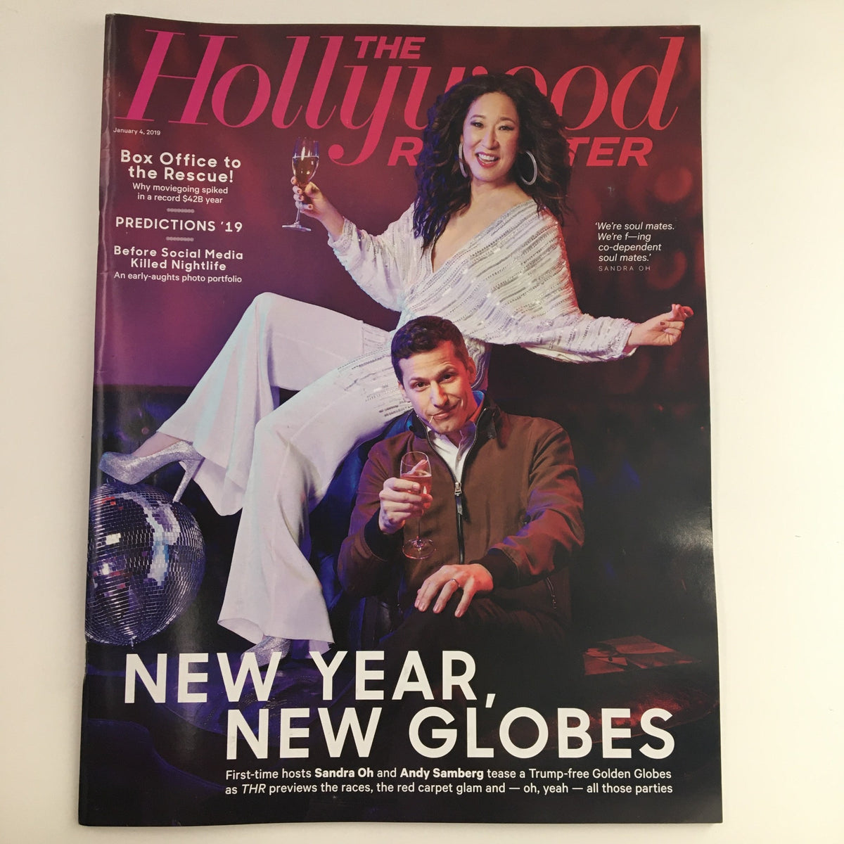 Cover of The Hollywood Reporter January 4 2019 featuring Sandra Oh and Andy Samberg holding drinks, celebrating the Golden Globe Awards and showcasing the theme 'New Year, New Globes'.