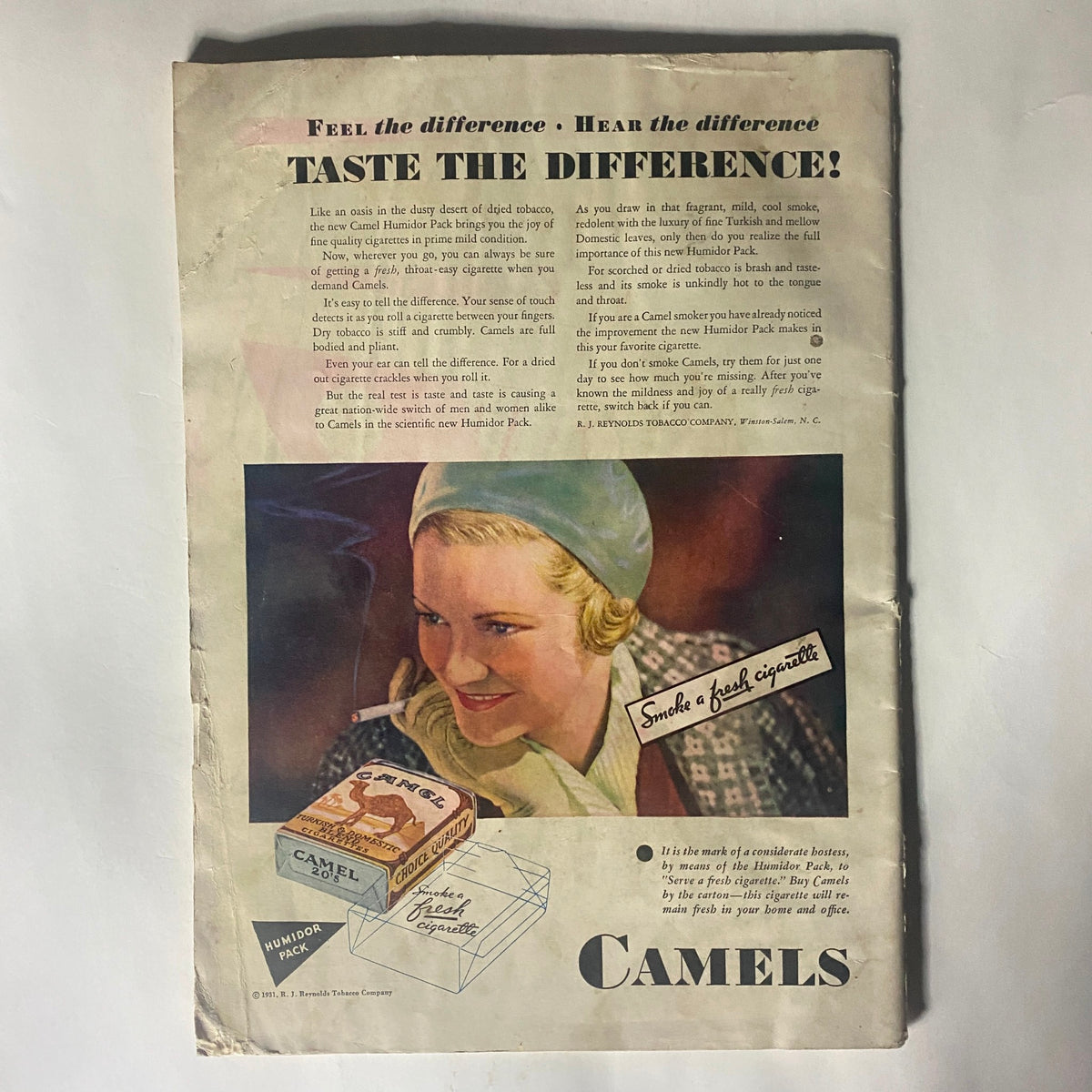 Vintage advertisement page for Camels cigarettes, featuring a woman smiling while holding a cigarette and information about the Humidor Pack.
