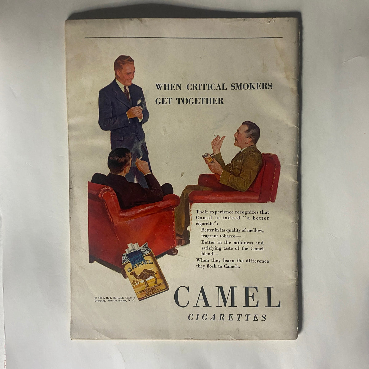 Back cover of The American Legion Magazine February 1930 featuring a vintage advertisement for Camel cigarettes, illustrating social moments of the era.