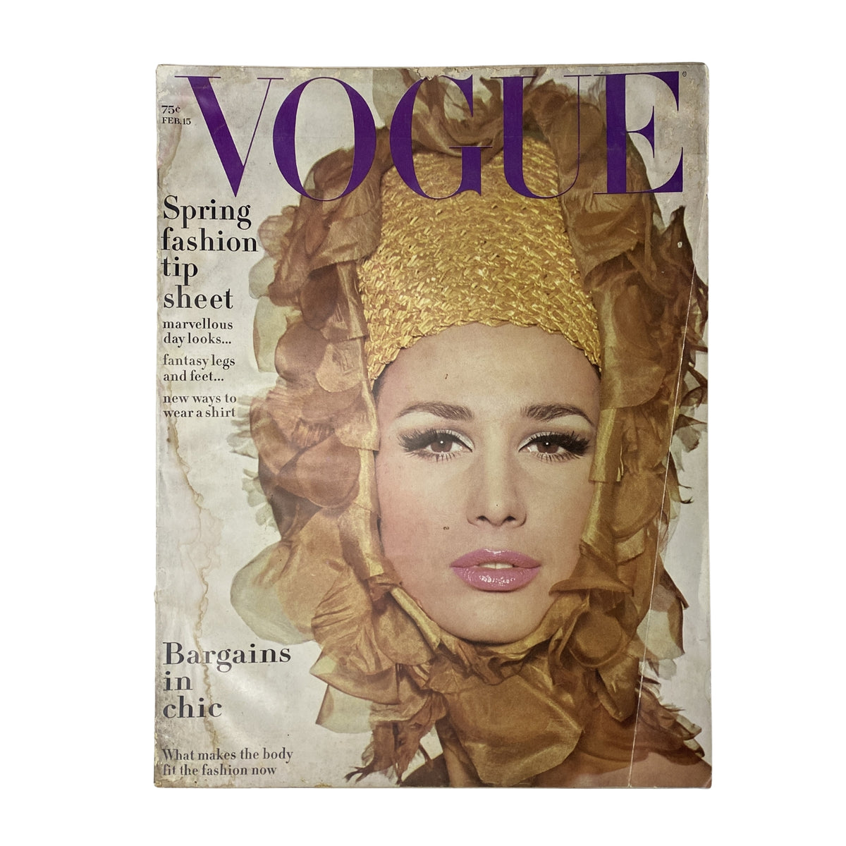 Vogue Magazine February 15, 1965 cover featuring striking model Brigitte Bauer in a gold headpiece, showcasing mid-60s fashion.