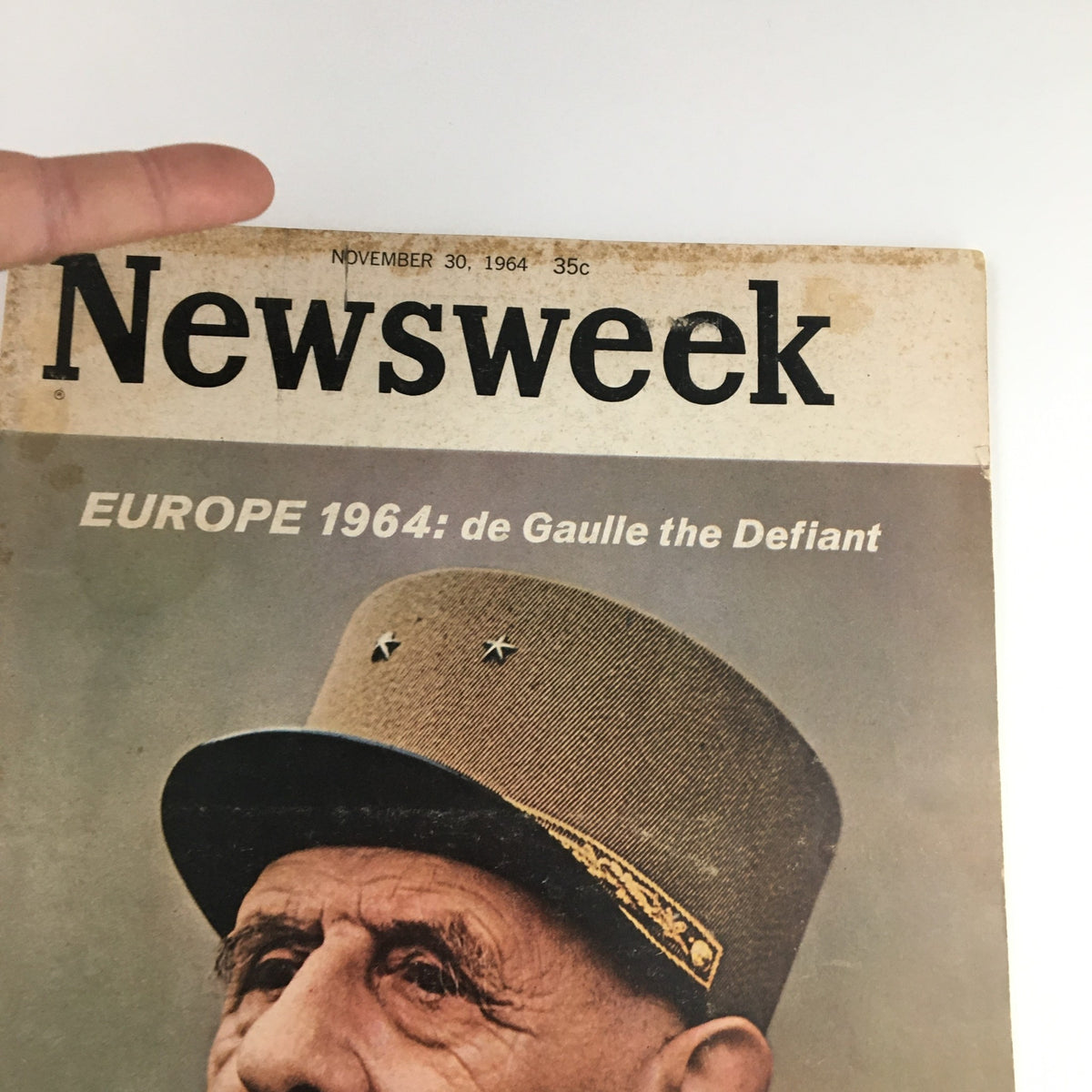 Close-up view of the vintage Newsweek magazine cover dated November 30, 1964, highlighting 'Europe 1964: de Gaulle the Defiant' with emphasis on de Gaulle's uniformed look.