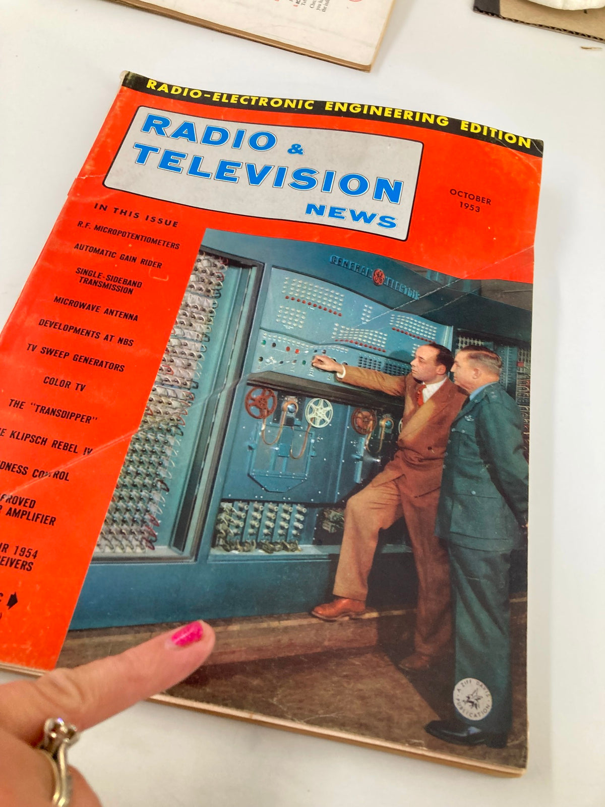 VTG Radio & Television News Magazine October 1953 cover with emphasis on R.F. Micropotentiometers and engineers examining electronic equipment.