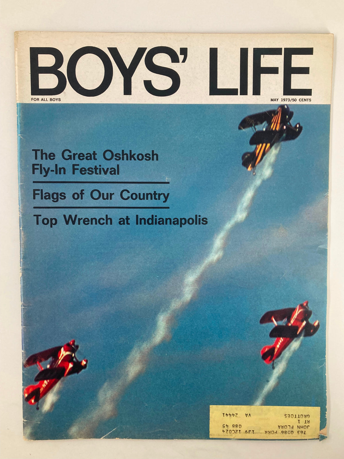 Cover of Boys' Life Magazine May 1973 featuring The Great Oshkosh Fly-In Festival with colorful biplanes performing aerial maneuvers against a blue sky background.