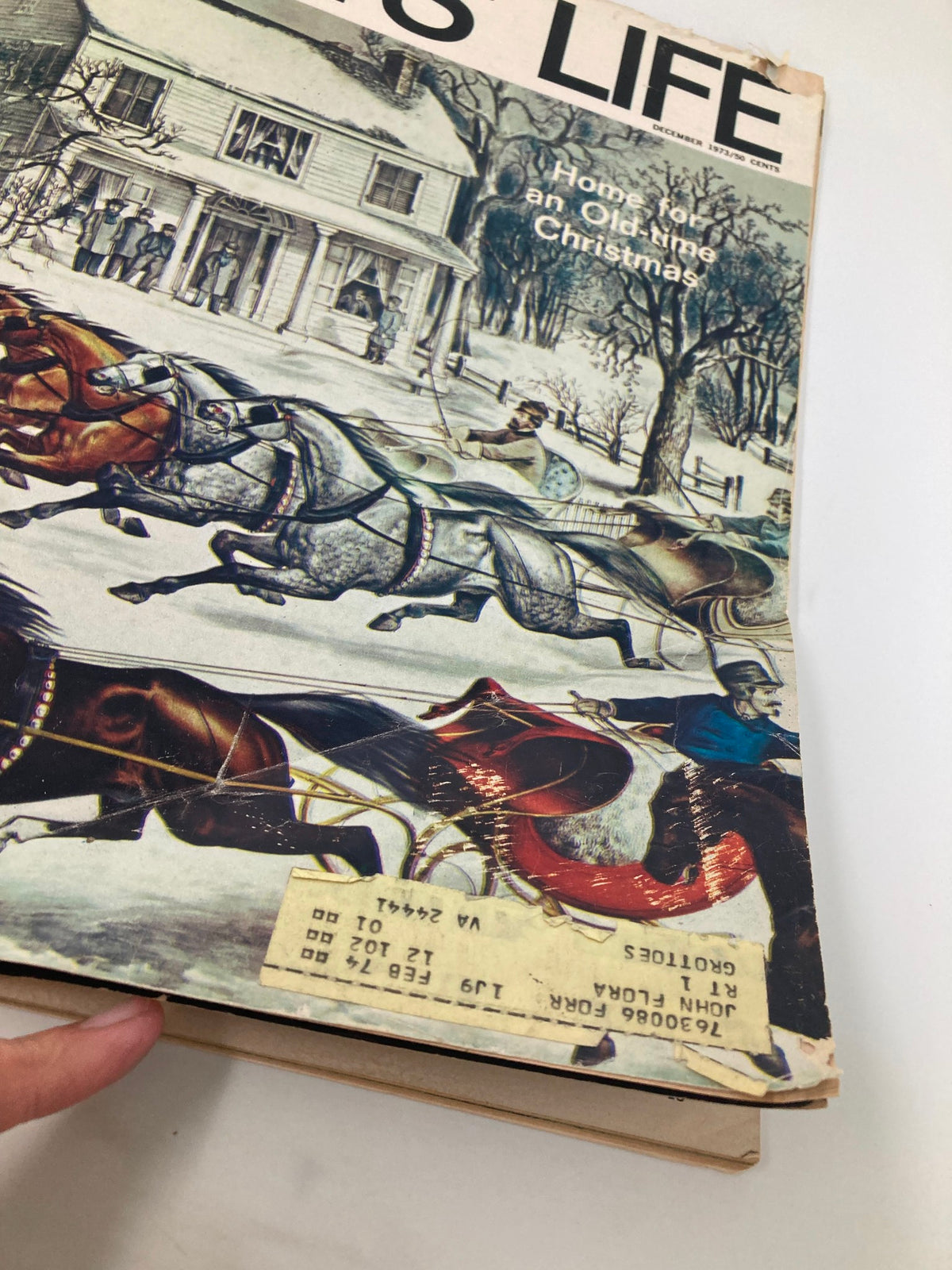 Side view of Boys' Life Magazine, December 1973, showing the title 'Home For An Old-Time Christmas' with a faded price tag and creased edges.