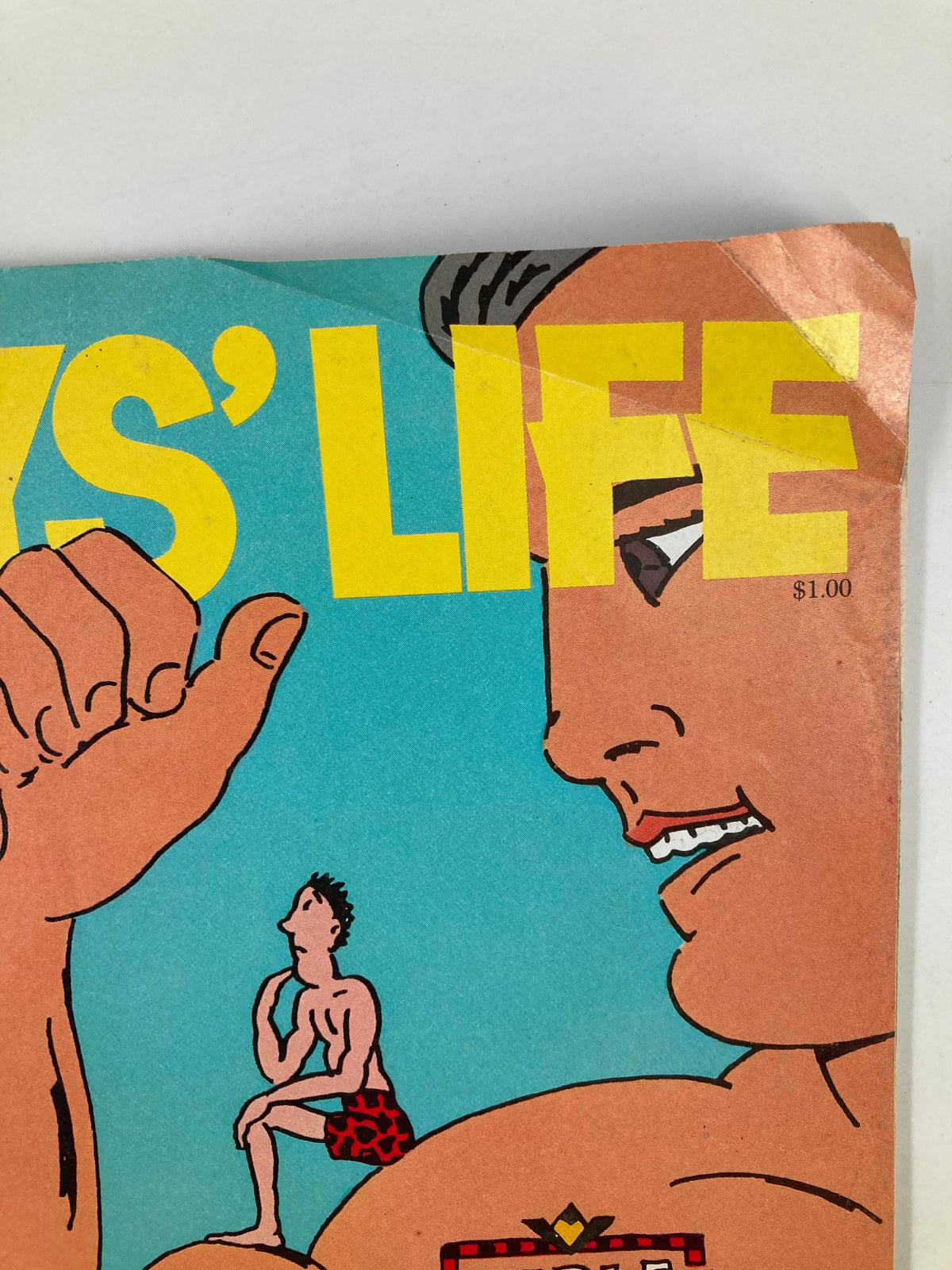 Close-up of the Boys' Life Magazine October 1983 cover showcasing the bold title and an illustration of a muscular man. The design captures the playful and adventurous spirit of the publication.
