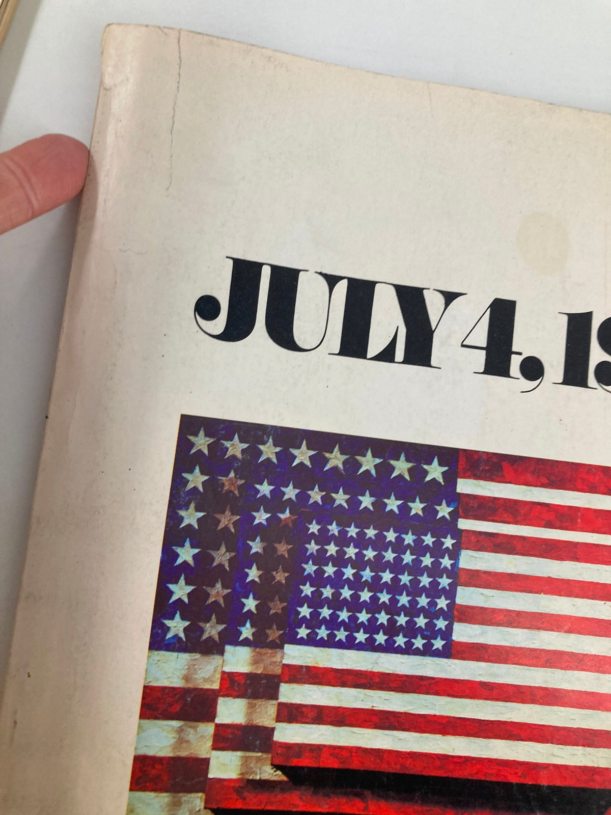 Close-up view of the spine and cover of the Vintage The Washington Post Magazine July 4 1976, showing some wear with a visible crack and faded colors.