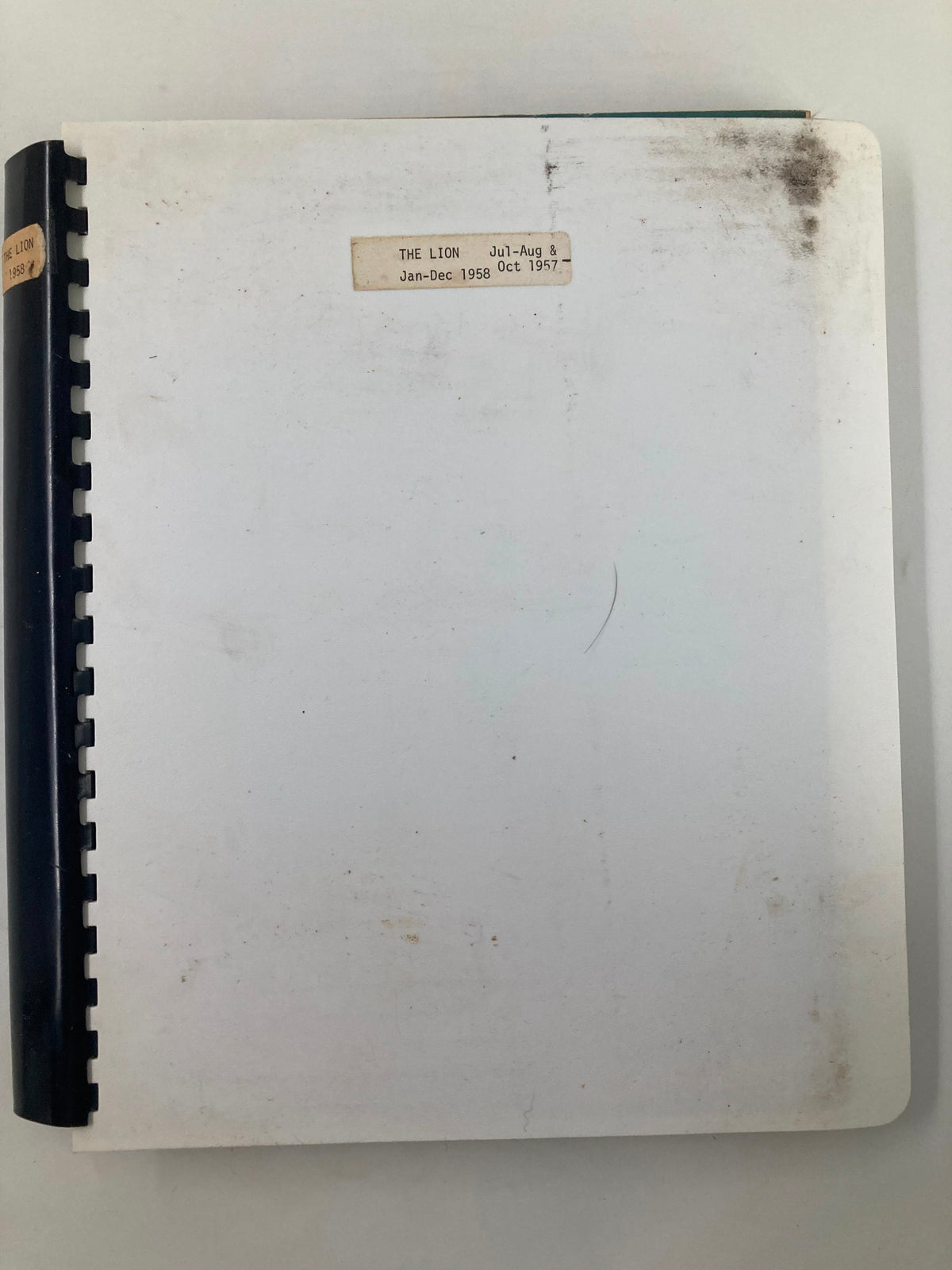 Back cover of The Lion magazine, featuring a plain white background with a label indicating the content of the July-August and January-December 1958 issues.
