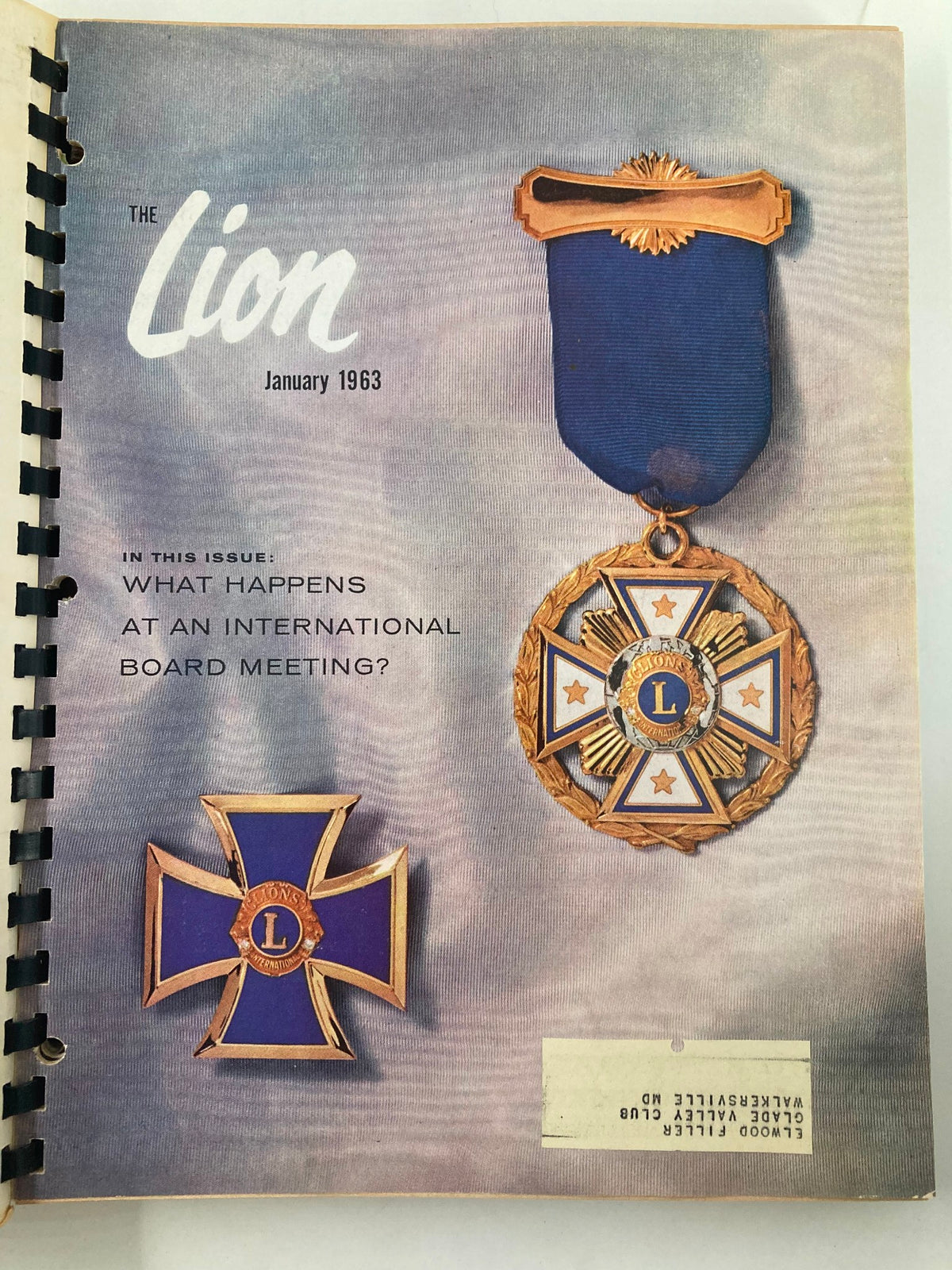 Cover of the January 1963 issue of The Lion Magazine featuring a blue ribbon and medals, highlighted with the title 'The Lion' and text about board meetings. This image is part of the 1963 January-December The Lion Magazine Full Year Hard Cover Compilation Issues.