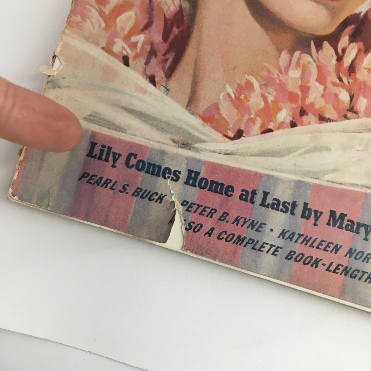 Close-up of the cover of Cosmopolitan Magazine April 1940 featuring the story 'Lily Comes Home at Last' by Mary Roberts Rinehart, highlighting vintage artwork.