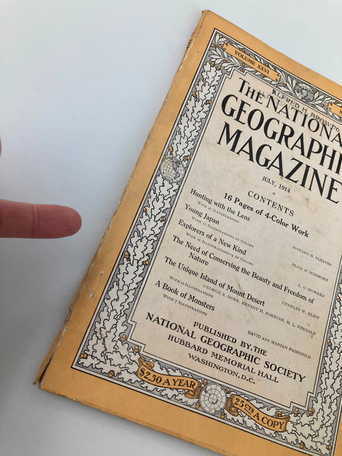 Detailed view of the cover of the National Geographic Magazine, July 1914, titled 'Explorers of a New Kind', highlighting the magazine's vintage condition and contents.