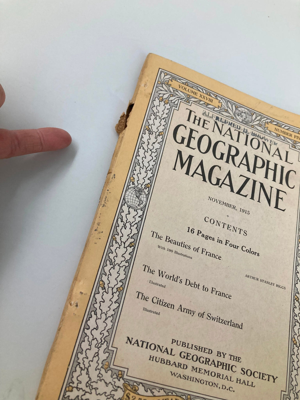 Close-up view of the cover of VTG The National Geographic Magazine November 1915 showing wear and tear, highlighting the historical condition of the magazine.