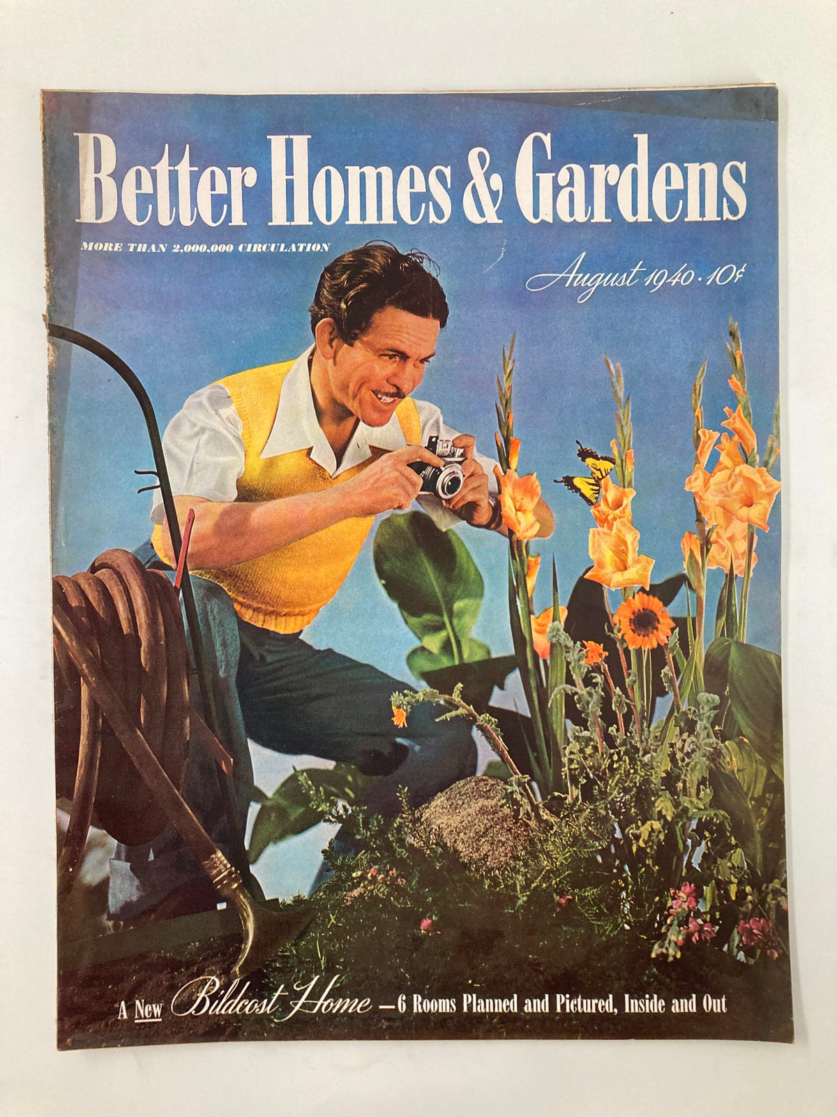 Cover of VTG Better Homes & Garden Magazine August 1940 showcasing a man with a camera amidst flowers, themed around home planning.