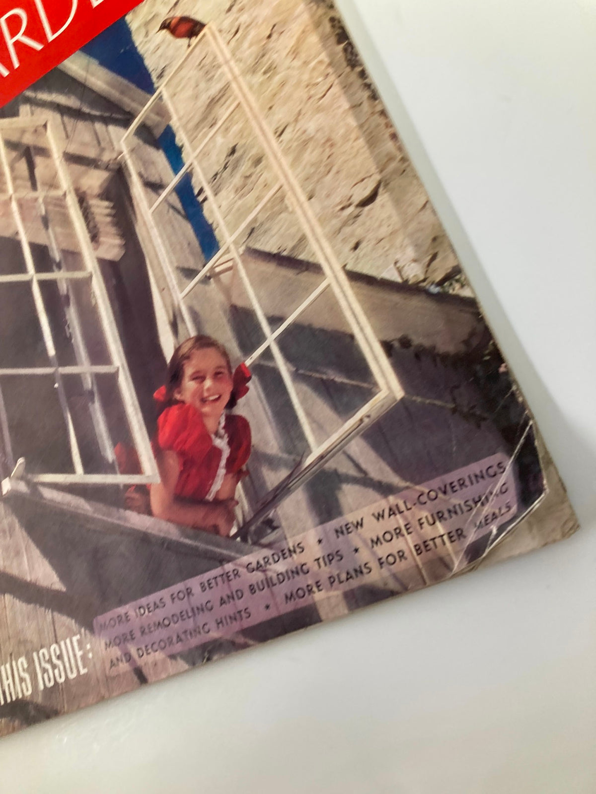 Cover of VTG Better Homes & Garden Magazine March 1938 featuring a girl in a red dress by a window with furnishings tips and decorating hints listed on the cover.