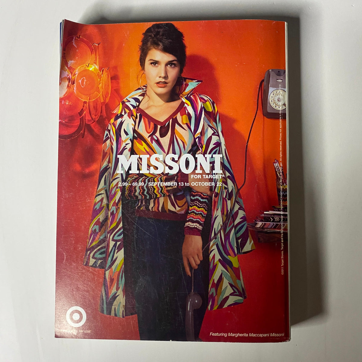 Vogue Magazine September 2011 Kate Moss Cover featuring a model in a retro Missoni for Target outfit against a striking red background, capturing the colorful essence of the brand.
