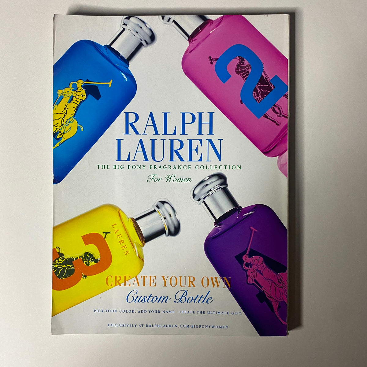 Vogue Magazine November 2012 advertisement for Ralph Lauren's 'Big Pony Fragrance Collection,' highlighting customizable fragrance bottles. This reflects the luxury branding associated with the magazine's fashion focus.