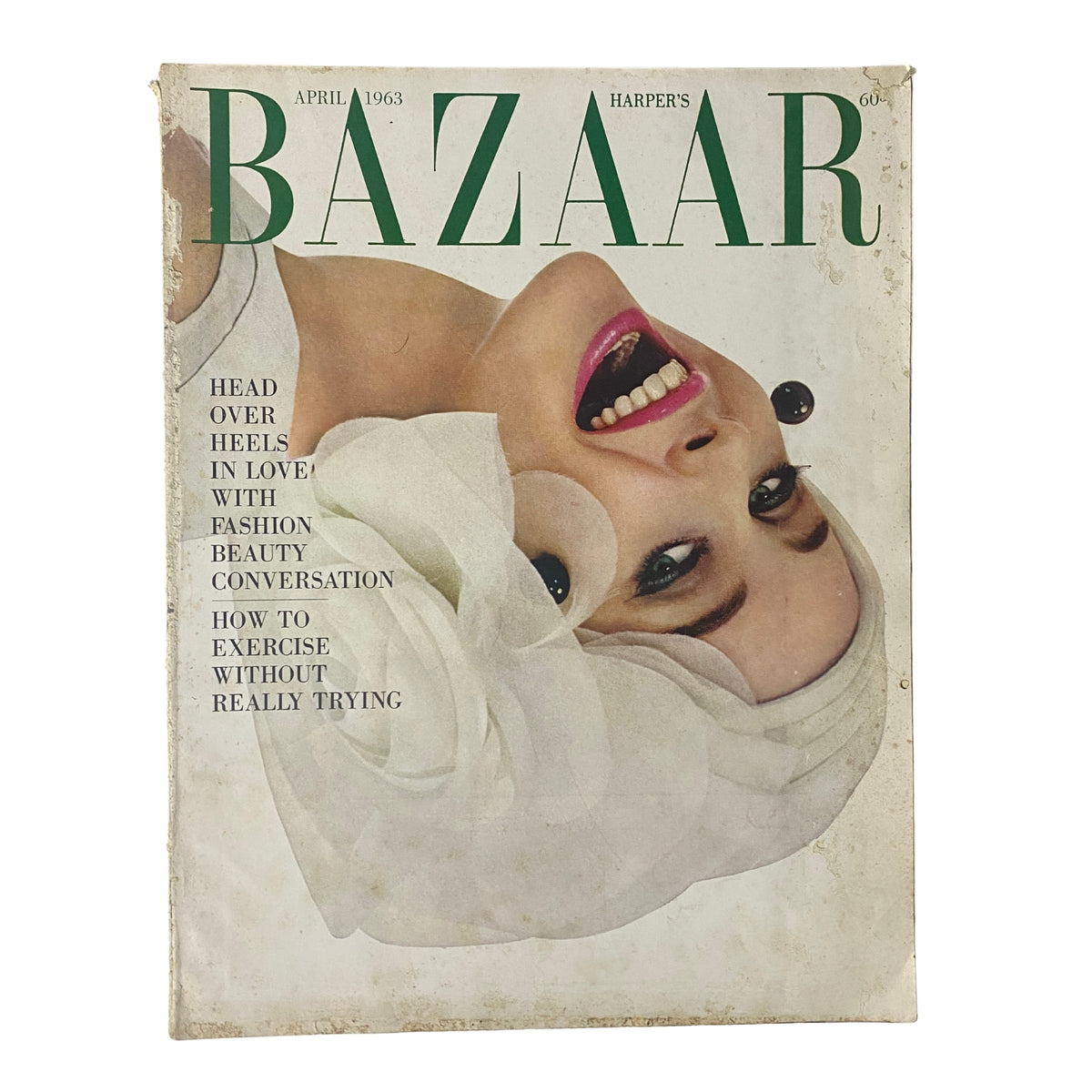 Harper's Bazaar Magazine April 1963 cover featuring a model with a bold, playful expression, promoting fashion and beauty.