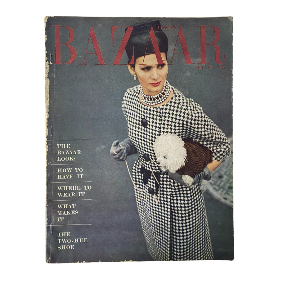 Harper's Bazaar Magazine February 1962 featuring the Youngest American Wardrobe. Cover showcases a model in a houndstooth dress, holding a fluffy pet, emphasizing early spring fashion.