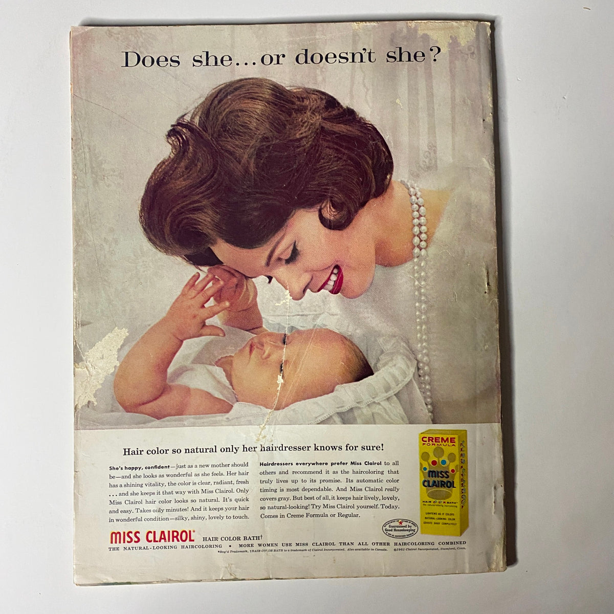 Advertisement from the back cover of Harper's Bazaar Magazine June 1961, featuring a woman showcasing hair color by Miss Clairol.