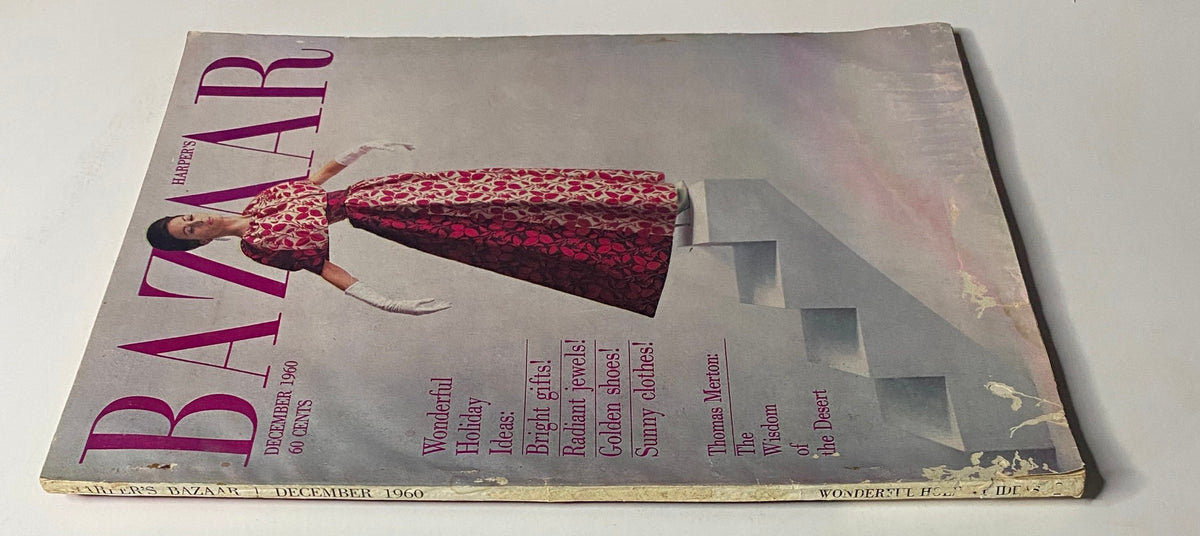 Side view of Harper's Bazaar Magazine December 1960, showcasing a stylish holiday cover with a model in a vibrant gown. The magazine emphasizes holiday ideas and features Thomas Merton's reflections.