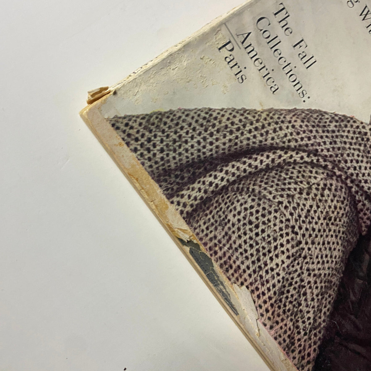 Close-up image of the damaged edges of Harper's Bazaar Magazine, September 1960, illustrating wear and historical significance of the America Paris Fall Collections issue.