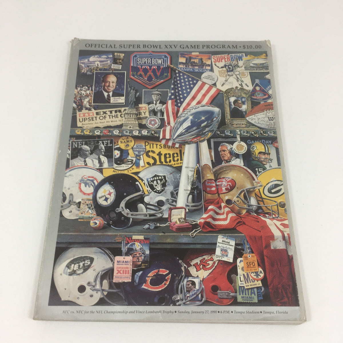 Official Super Bowl XXV Game Program from January 27, 1991, featuring iconic football memorabilia, including team helmets, the Vince Lombardi Trophy, and various historic elements from the game.