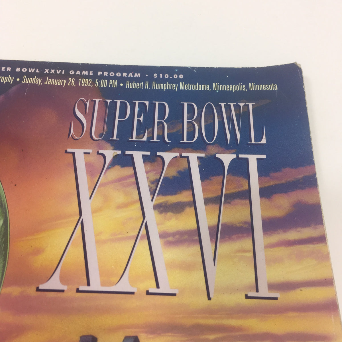 Cover page detail of the Super Bowl XXVI Game Program dated January 26, 1992, showcasing the title prominently against a sunset background.
