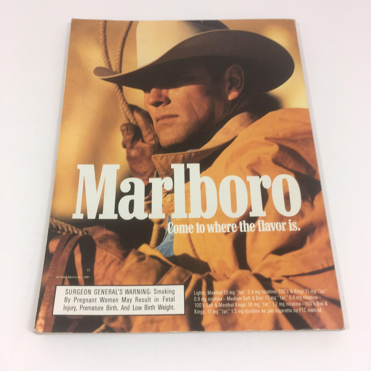 Front cover of the Super Bowl XXVI Game Program from January 26, 1992, displaying a cowboy in a hat and the Marlboro logo with the tagline 'Come to where the flavor is.'