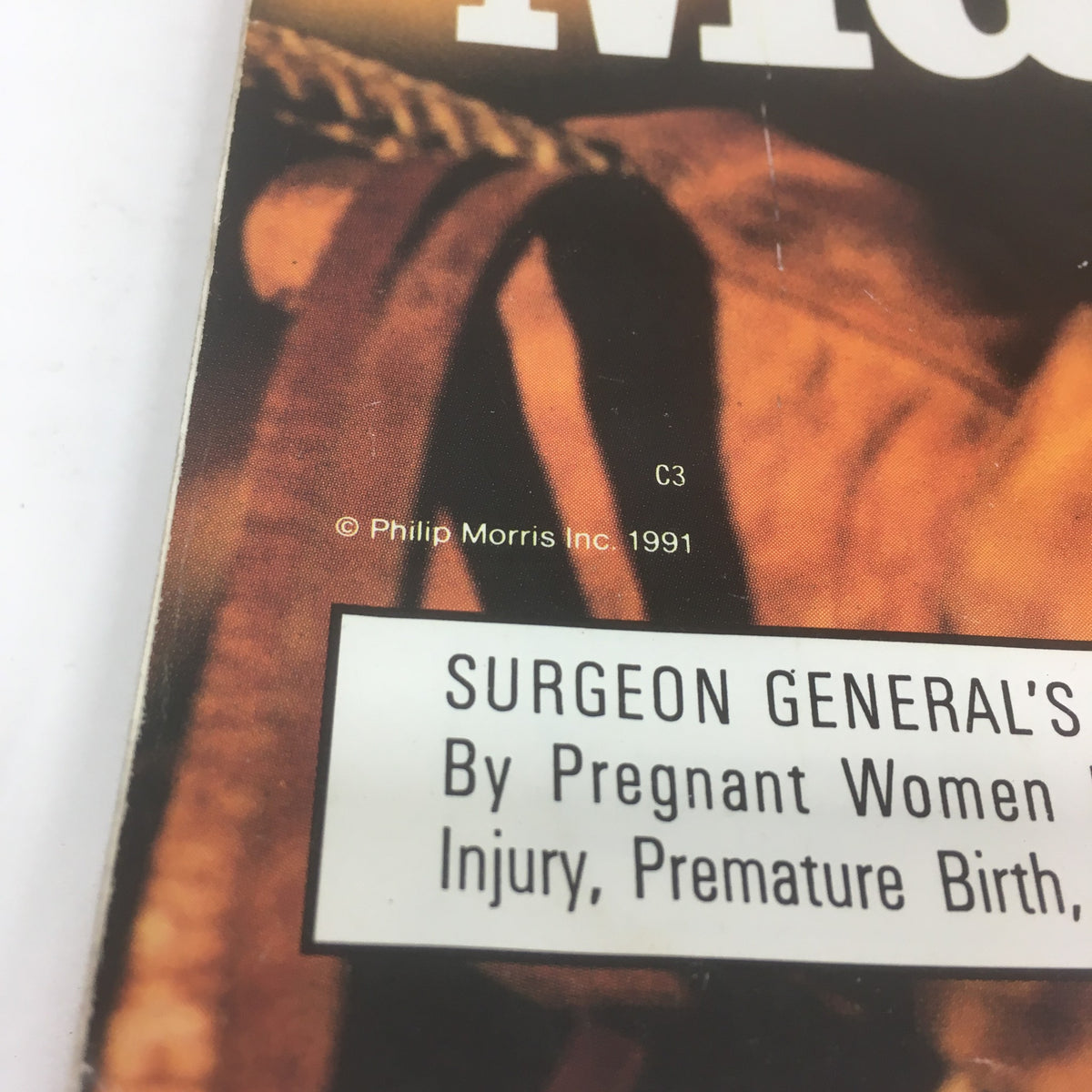 Close-up of the details on the Super Bowl XXVI Game Program from January 26, 1992, highlighting the surgeon general's warning regarding smoking on the Marlboro advertisement.