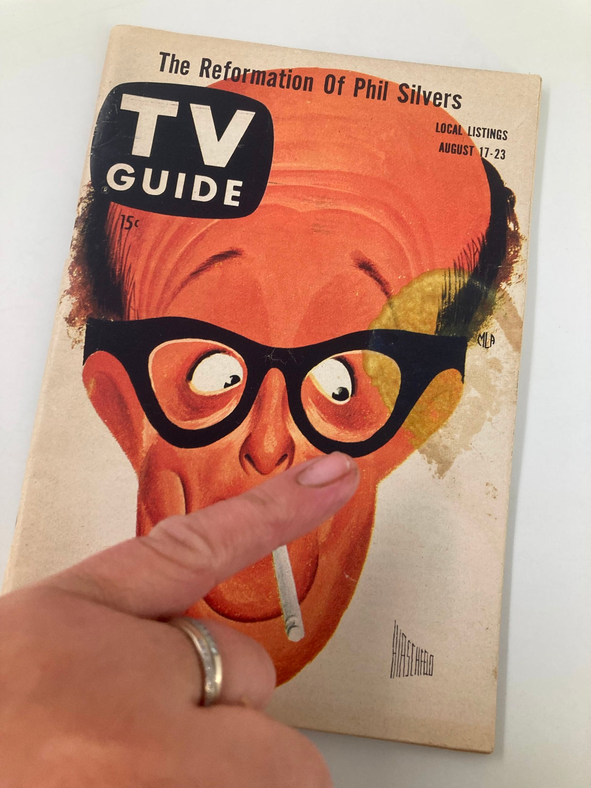 Close-up of the cover of TV Guide Magazine August 17 1957 with Phil Silvers, displaying the magazine title and an artistic representation of the character.