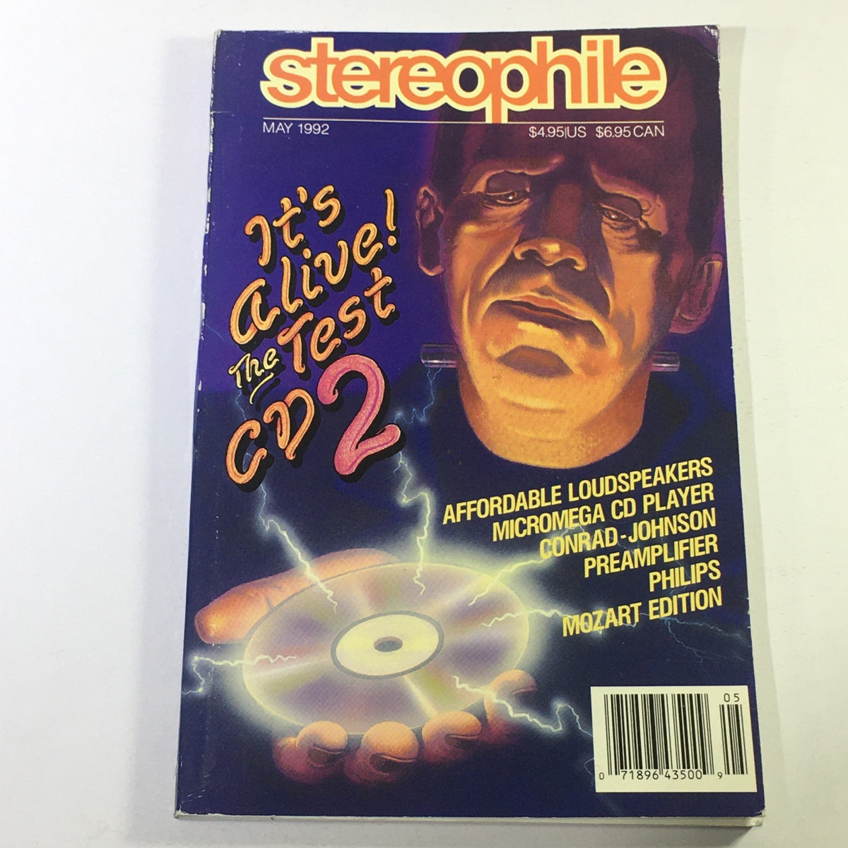 Cover of Stereophile Magazine May 1992 featuring the headline 'It's Alive! The Test CD 2' with a graphic illustration of a man and a CD, highlighting Conrad-Johnson Preamplifier and Philips Mozart Edition.