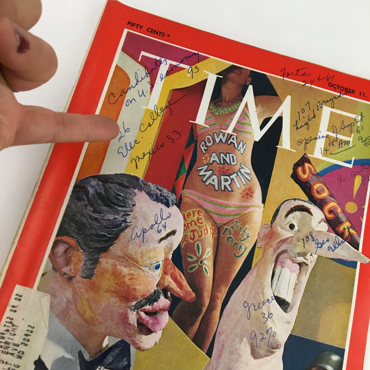Close-up of the Time Magazine Cover from October 11, 1968 depicting comedians Dick Martin and Dan Rowan with visible handwritten details emphasizing its historical context.