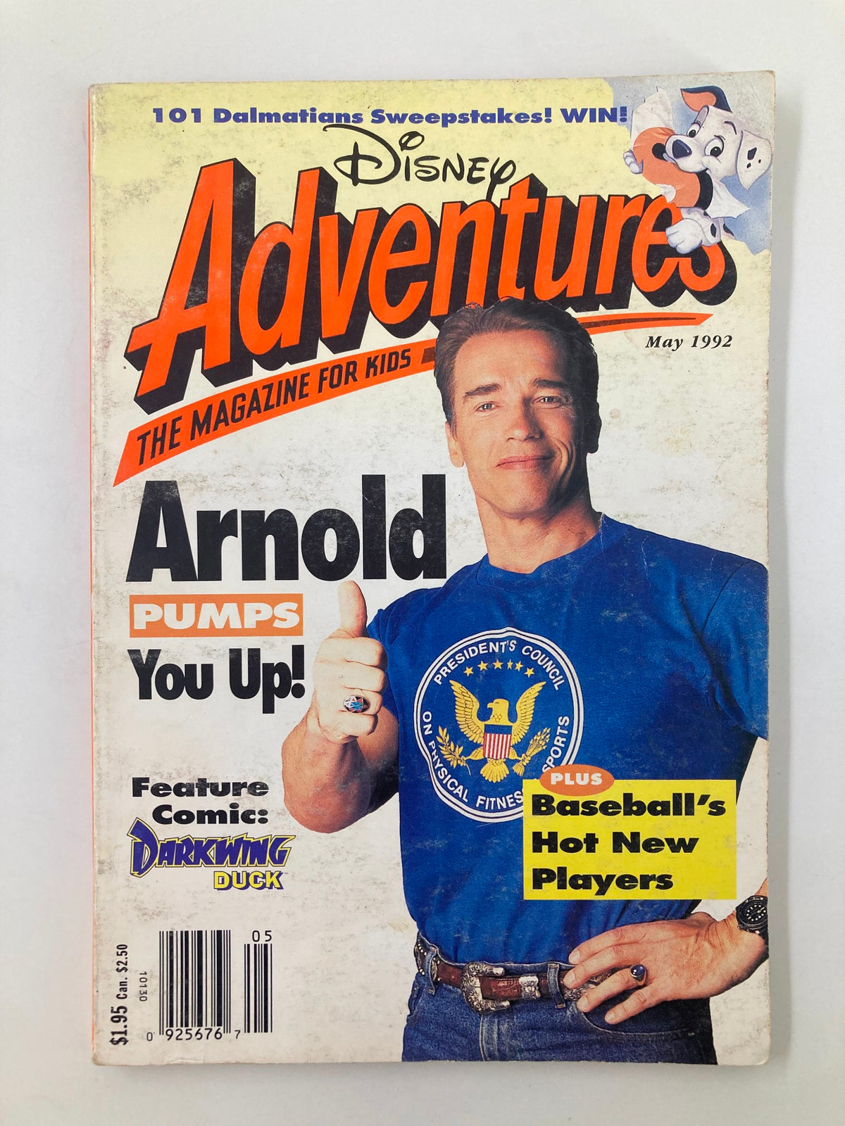 Cover of Disney Adventures Magazine May 1992 featuring Arnold Schwarzenegger with the headline 'Pumps You Up!' and colorful graphics including a promotional for 101 Dalmatians Sweepstakes.