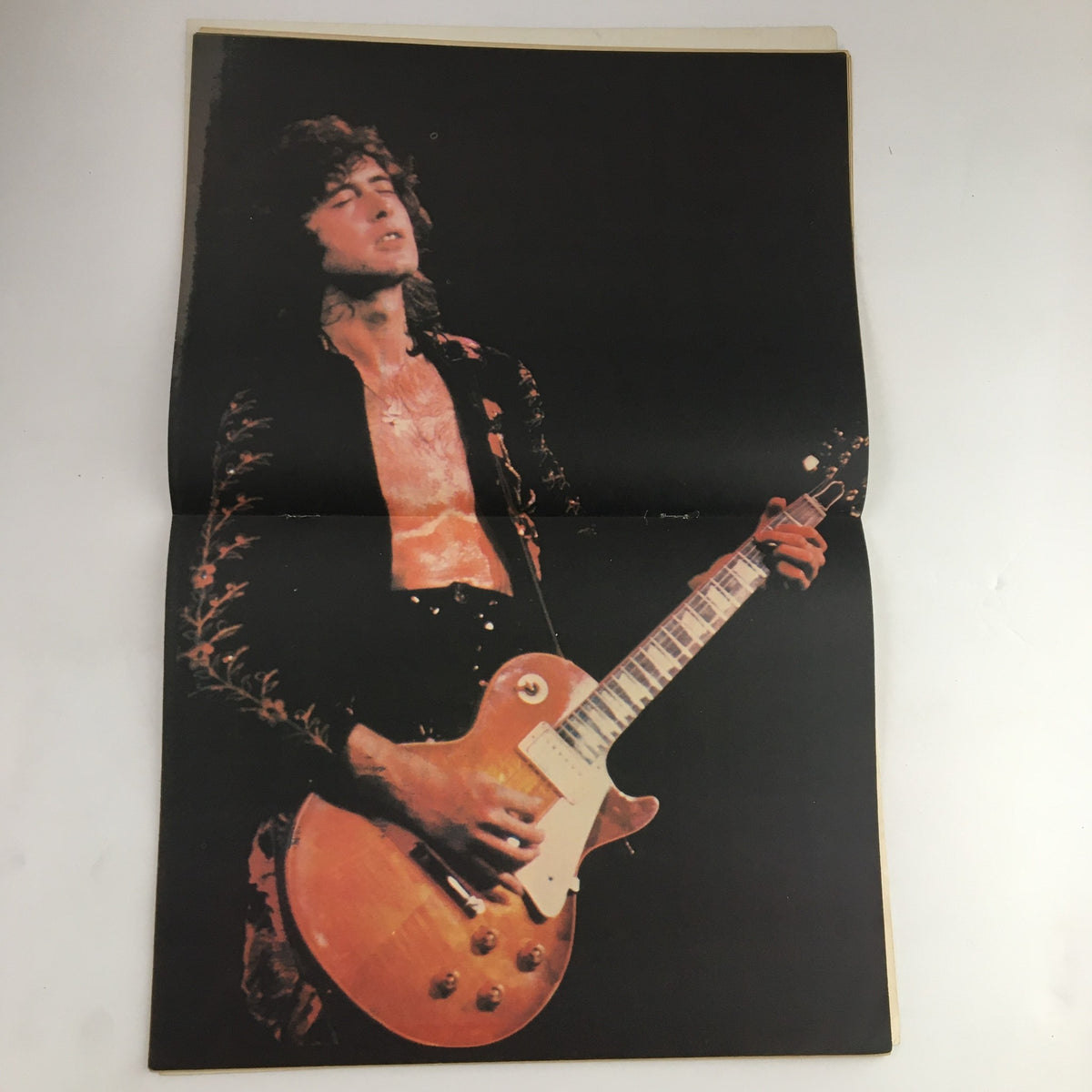 Stunning fold-out image of a guitarist from Led Zeppelin featured in Hit Parader Magazine May 1975, capturing the essence of rock music in the 70s.