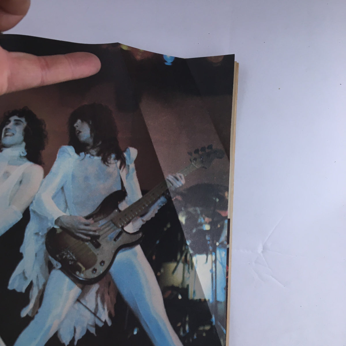 Close-up of a two members from a rock band in white costumes from Hit Parader Magazine August 1977, highlighting the band's performance style.