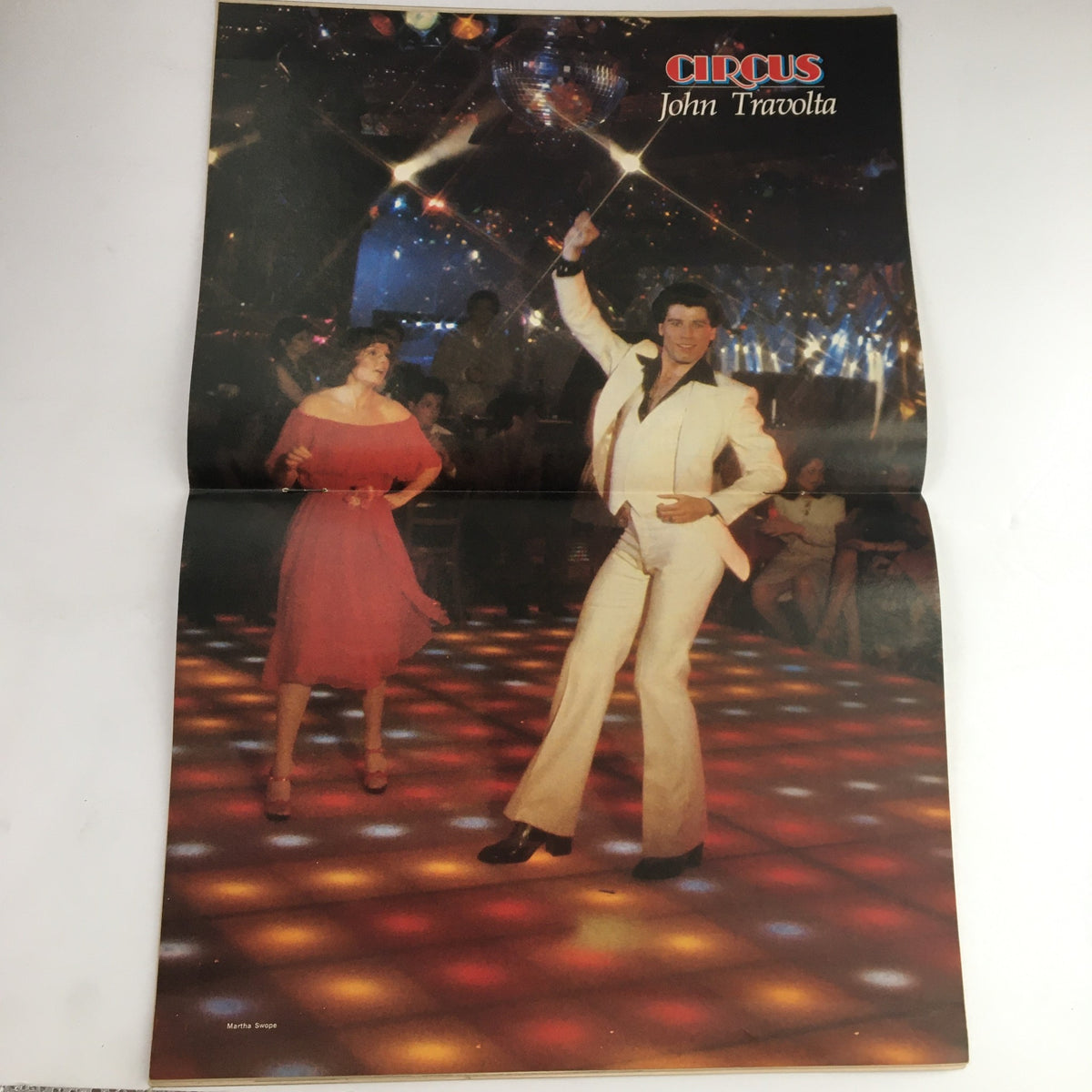 Poster inside Circus Magazine from May 11, 1978, showcasing John Travolta dancing, capturing the disco era's essence.