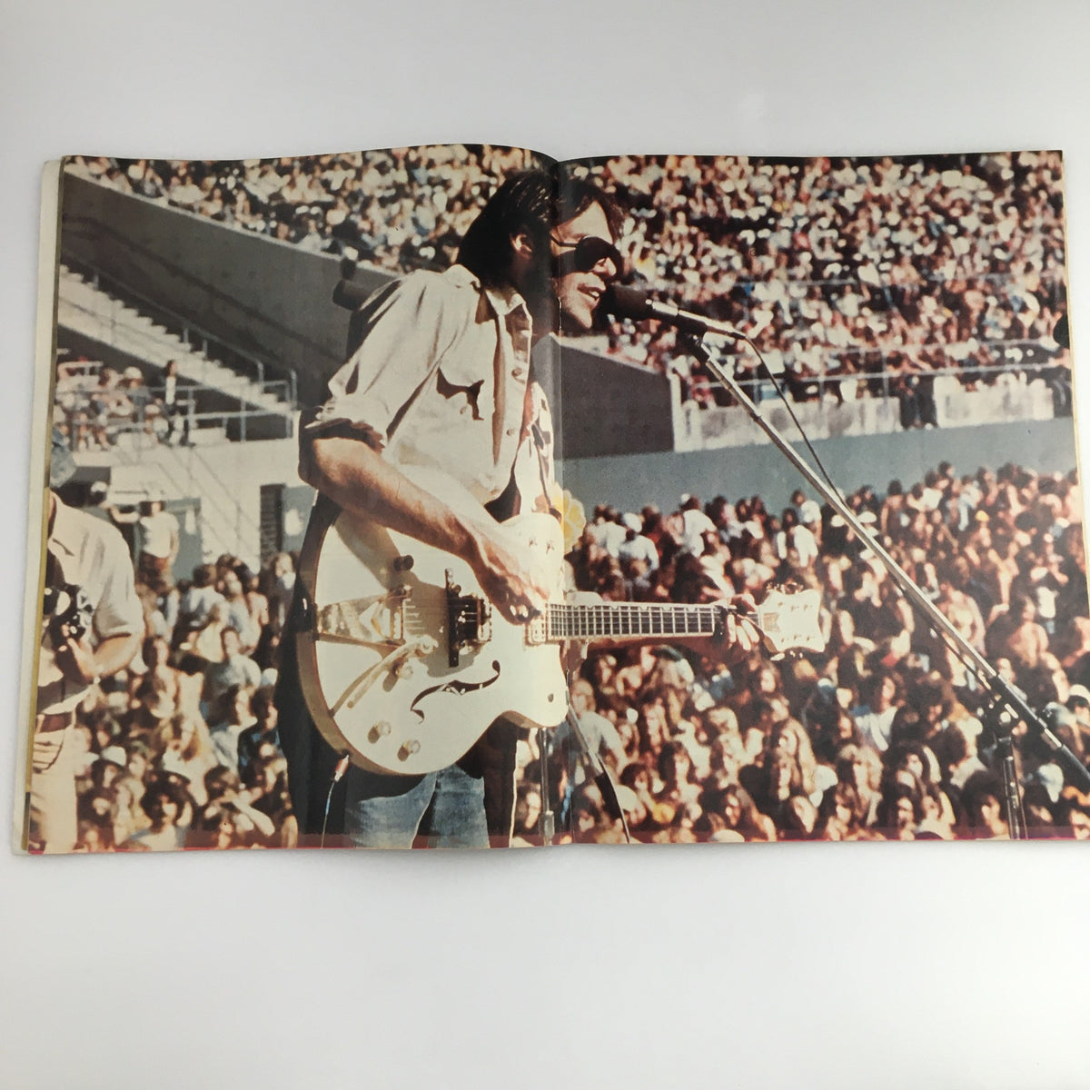 Hit Parader Magazine February 1975 featuring a live performance photo of a musician with a guitar, capturing the vibrant atmosphere of a 1970s concert and showcasing the era's rock culture.