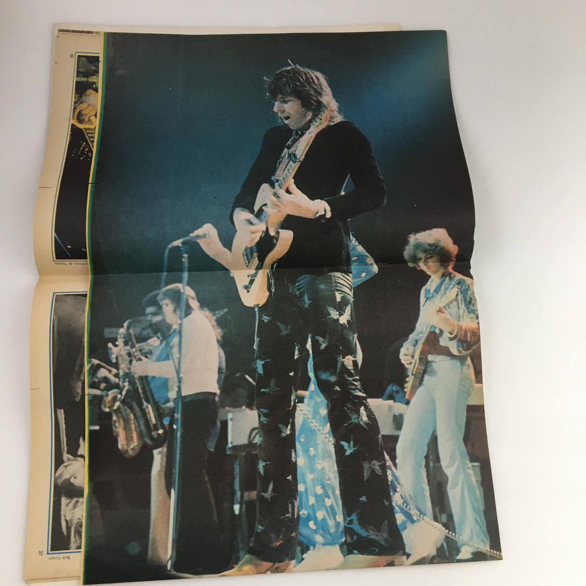 Live performance image from Hit Parader Magazine, March 1975 featuring a musician playing guitar on stage, encapsulating the vibrant energy of the 1970s rock music scene.