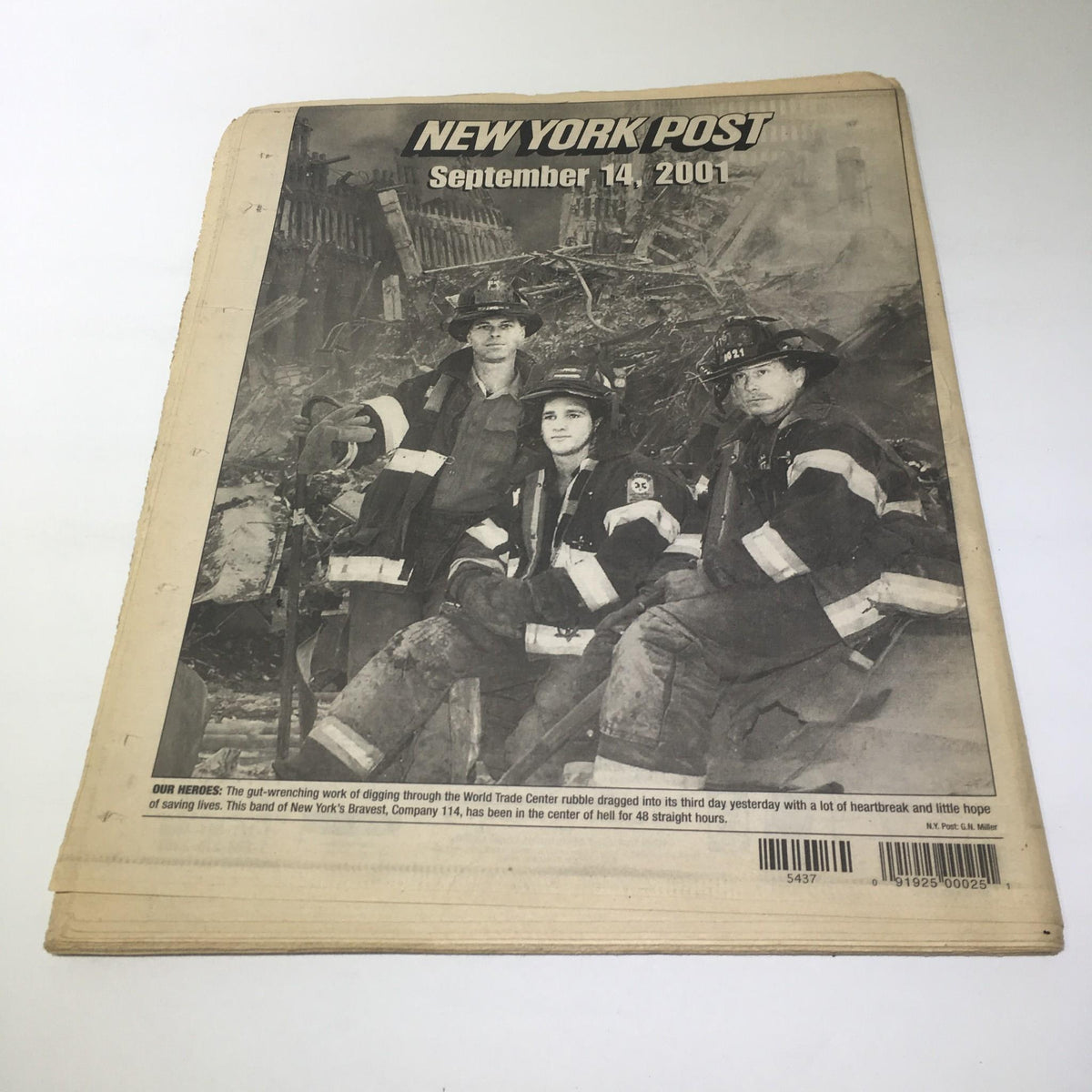 New York Post: Sept 14 2001, New York's Tragic Face showing firefighters posing amidst the rubble of the World Trade Center, capturing the aftermath of the 9/11 disaster.