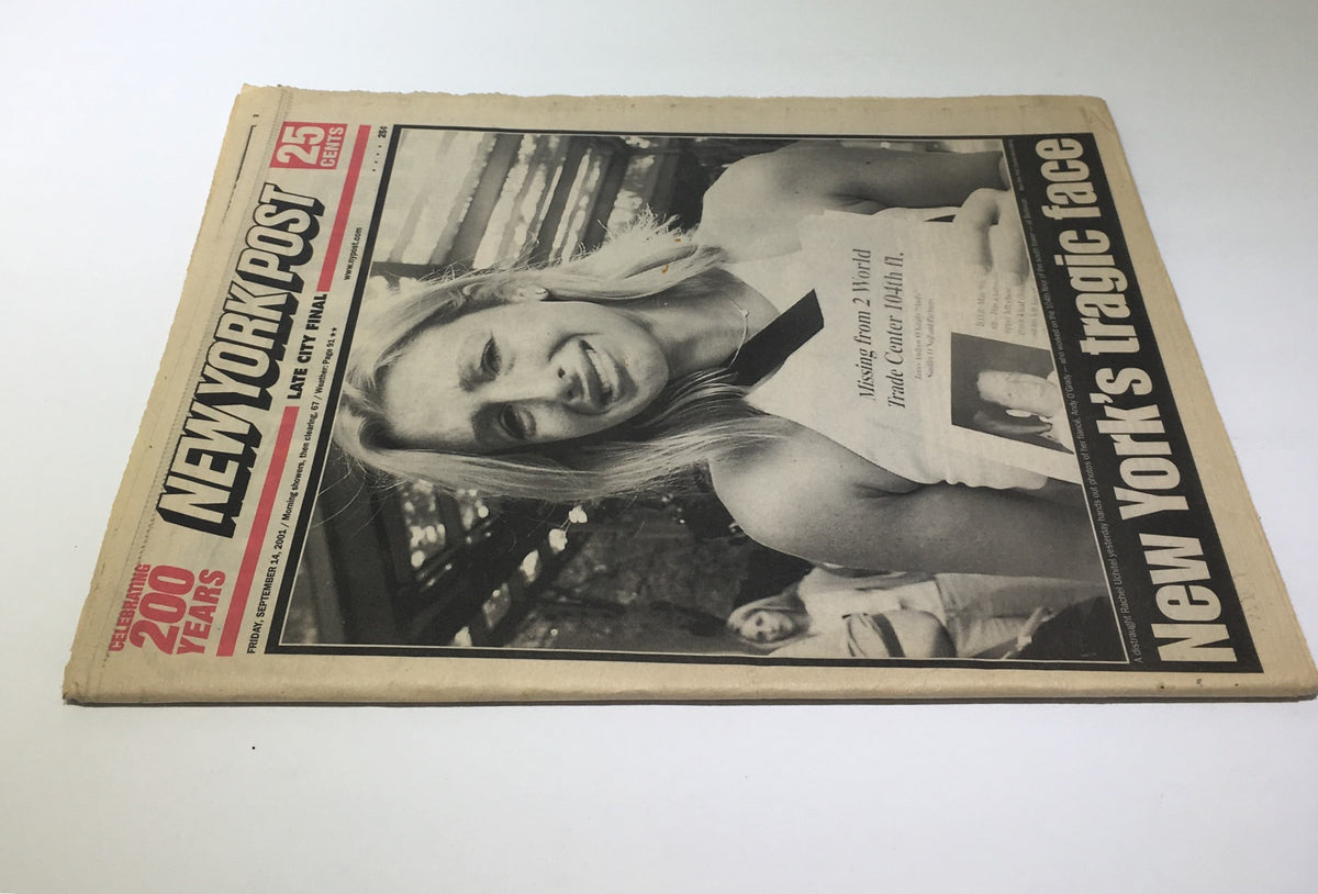 New York Post: Sept 14 2001, New York's Tragic Face - An angled perspective of the newspaper displaying the significant headline, capturing the somber feelings associated with New York's history.
