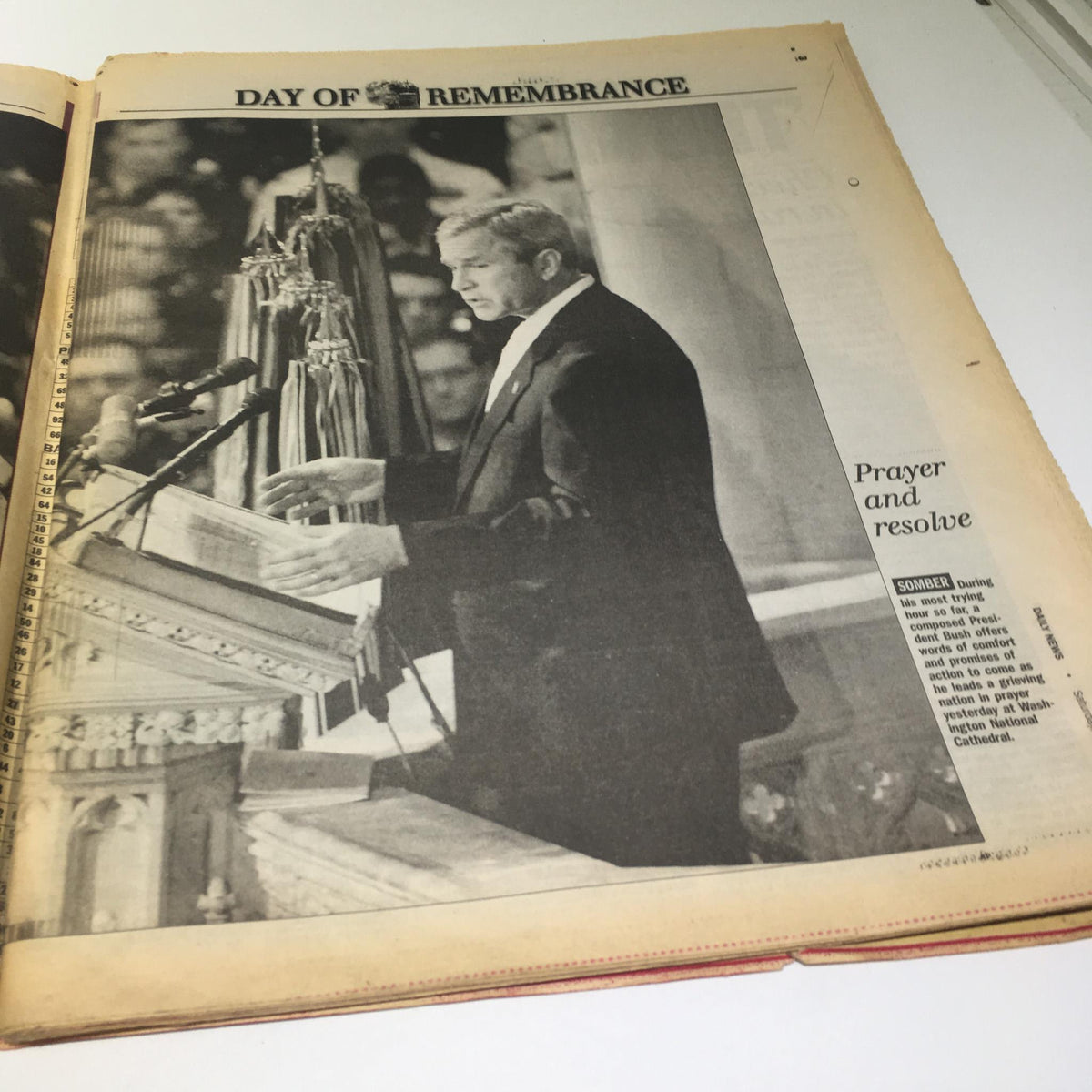 New York Daily 911 President George W Bush Rememberence Special edition. Interior page featuring President Bush delivering a speech at a memorial service, with the text 'Prayer and resolve,' encapsulating a moment of national unity.