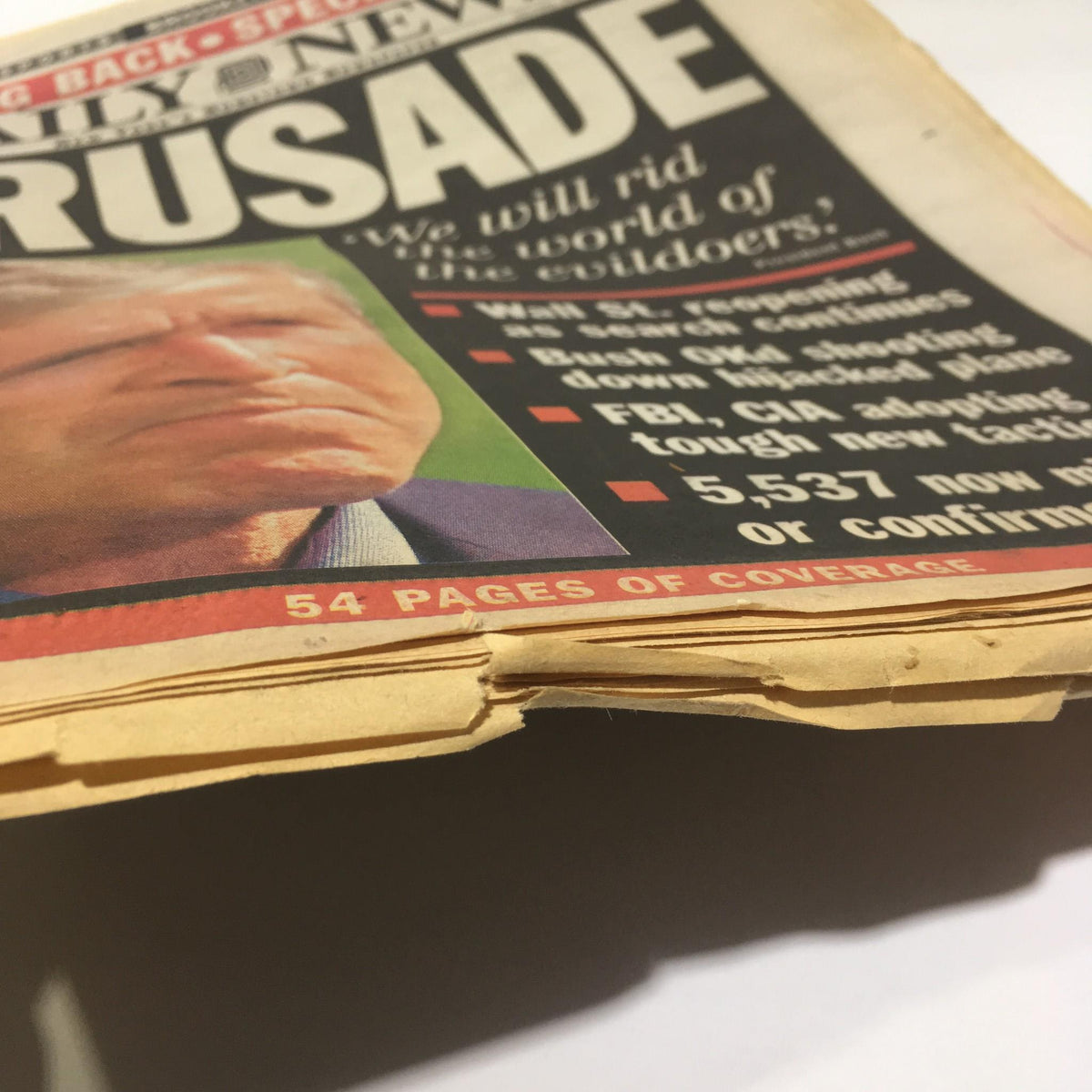 NY Daily News September 17, 2001 cover featuring President Bush with the headline 'We Will Rid the World of The Evildoers' - visible wear and age on the edges of the newspaper.